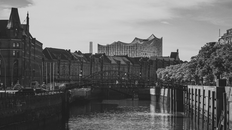 A moody view of Hamburg’s Speicherstadt district, with the iconic Elbphilharmonie concert hall rising in the background.