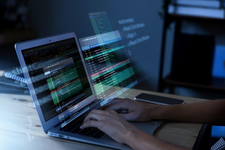 Programming background with person working with codes on computer