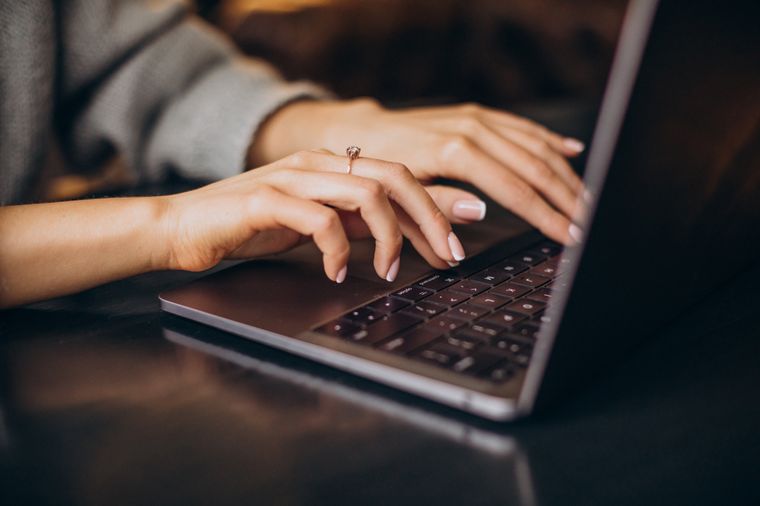 Female hands typing computer keyboard