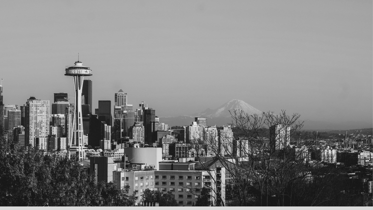 The Seattle skyline with the Space Needle in the foreground and Mount Rainier visible in the background