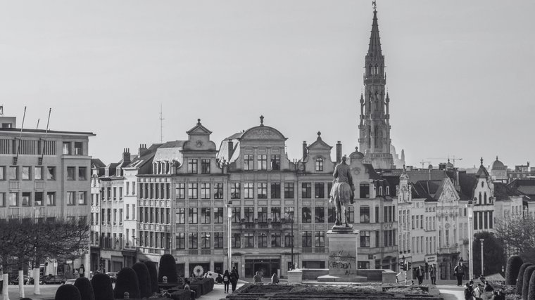 A classic cityscape of Brussels from Mont des Arts, showcasing grand architecture and the spire of the Town Hall in the distance.