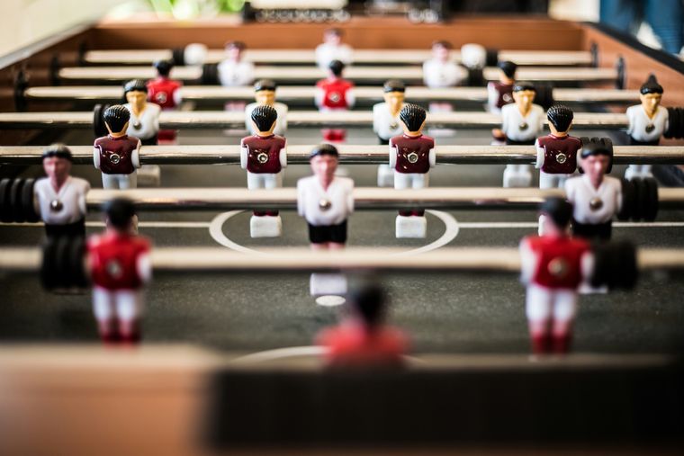 A close-up photo of the figures on a table soccer table