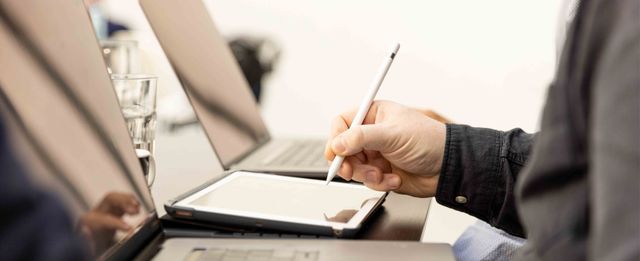 Team member using a tablet with a stylus